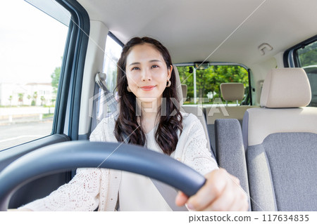 A young woman driving 117634835