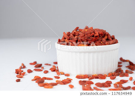 Dried Goji berries in a plate on a white background 117634949