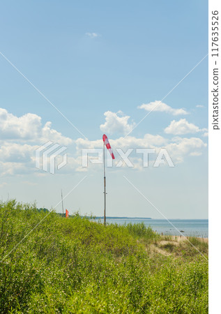 Coastline of the Baltic Sea with red white wind flag . High quality photo 117635526