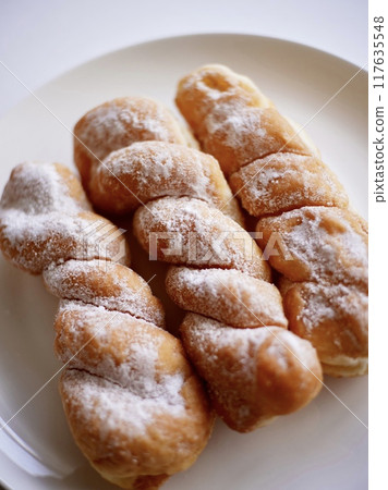 Twisted bread on a white plate Twisted bread on a white plate 117635548