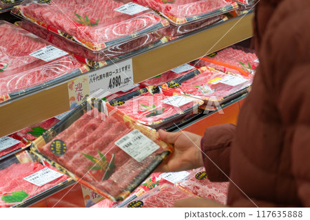 Pick up meat for New Year's at the supermarket Pick up meat for New Year's at the supermarket 117635888