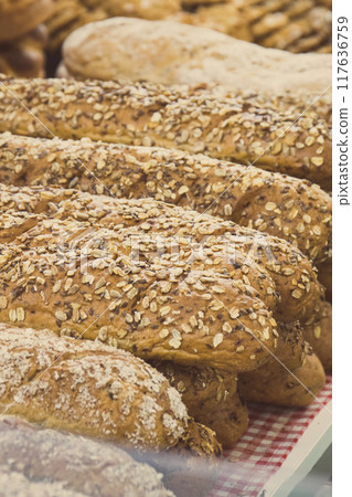 Freshly baked wholegrain baguette with grains in bakery Freshly baked wholegrain baguette with grains in bakery 117636759