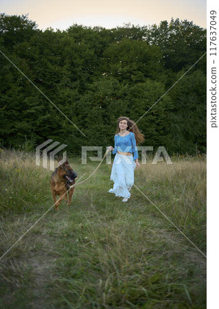 a woman in a Whimsical Aesthetic style dress with a German shepherd in a field a woman in a Whimsical Aesthetic style dress with a German shepherd in a field 117637049