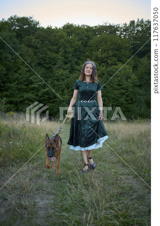 a woman in a Whimsical Aesthetic style dress with a German shepherd in a field 117637050