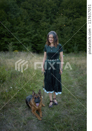 a woman in a Whimsical Aesthetic style dress with a German shepherd in a field a woman in a Whimsical Aesthetic style dress with a German shepherd in a field 117637051