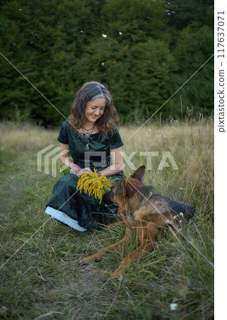 a woman in a Whimsical Aesthetic style dress with a German shepherd in a field a woman in a Whimsical Aesthetic style dress with a German shepherd in a field 117637071