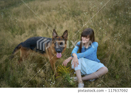 a woman in a Whimsical Aesthetic style dress with a German shepherd in a field a woman in a Whimsical Aesthetic style dress with a German shepherd in a field 117637092