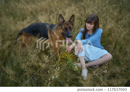 a woman in a Whimsical Aesthetic style dress with a German shepherd in a field a woman in a Whimsical Aesthetic style dress with a German shepherd in a field 117637093