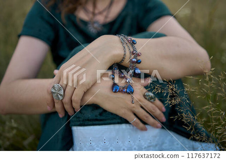 woman in whimsical aesthetic style dress in field in summer at sunset woman in whimsical aesthetic style dress in field in summer at sunset 117637172