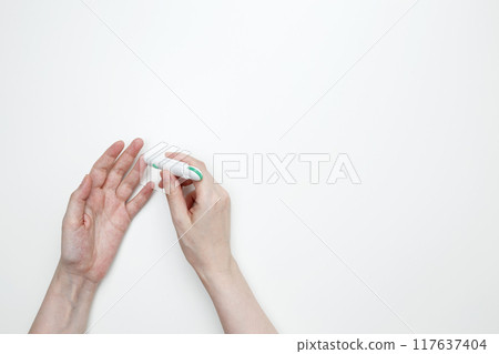 Woman using glucometer for testing level Blood sugar. Top view. Copy space 117637404