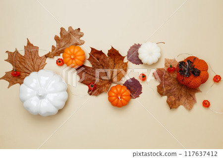 Autumn composition with maple leaves, decorative pumpkins and candles. Top view. Copy space 117637412