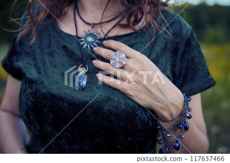 woman in whimsical aesthetic style dress in field in summer at sunset 117637466