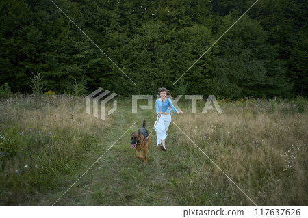 a woman in a Whimsical Aesthetic style dress with a German shepherd in a field a woman in a Whimsical Aesthetic style dress with a German shepherd in a field 117637626