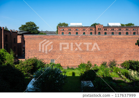 Hamburg, Germany, July 19, 2024 - Brick stone facade of multi story social housing block 117637999