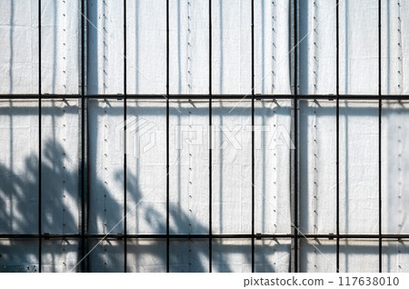 Detail of a concrete and steel grid with hard sunlight and shadows, Hamburg, Germany, 117638010