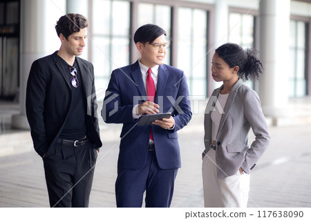 Group young business man and woman meeting and discussing documents on a tablet. 117638090