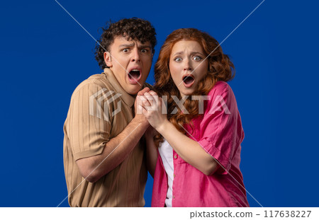 Frightened white american couple afraid of something. Man and woman in shock. Frightened white american couple afraid of something. Man and woman in shock. 117638227