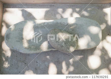 Stones for grinding grain. The ancient way. Stone and mortar 117638291