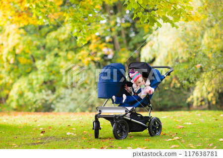 Child in fall park. Kid with autumn leaves. Child in fall park. Kid with autumn leaves. 117638781