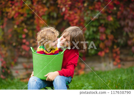 Child in fall park. Kid with autumn leaves. Child in fall park. Kid with autumn leaves. 117638790