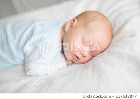 Little baby on white bed Little baby on white bed 117638877