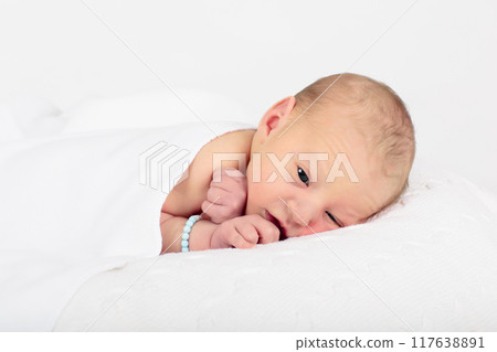 Newborn baby boy in hospital cot Newborn baby boy in hospital cot 117638891