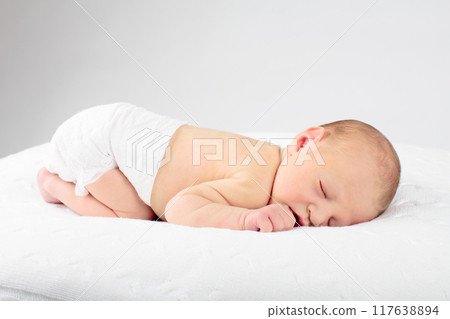 Newborn baby boy in hospital cot Newborn baby boy in hospital cot 117638894