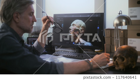 Mature archaeologist uses tablet computer and PC and creates 3D model 117640641