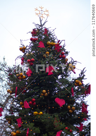 Christmas tree on the street with red Christmas decorations Christmas tree on the street with red Christmas decorations 117640669