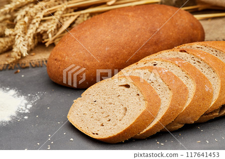 Whole wheat bread loaf sliced, showcasing its hearty texture and rich, wholesome flavor Whole wheat bread loaf sliced, showcasing its hearty texture and rich, wholesome flavor 117641453