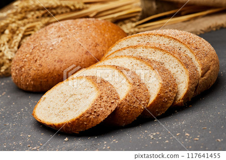 Whole wheat bread loaf sliced, showcasing its hearty texture and rich, wholesome flavor 117641455