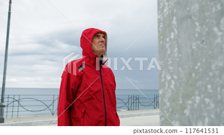 Man With Raincoat At The Seafront Man With Raincoat At The Seafront 117641531