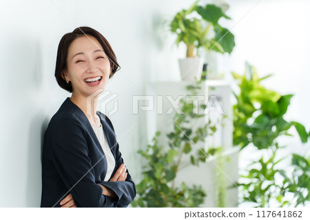 Portrait of a business woman relaxing in the office 117641862