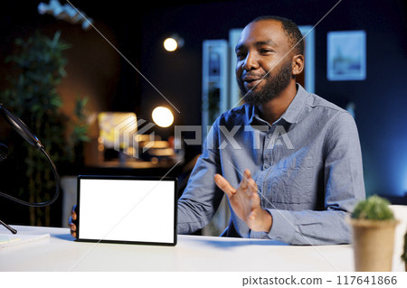 African american content creator holding isolated screen tablet in his hands, talking about specifications to online audience. Internet show host presenting mockup device features African american content creator holding isolated screen tablet in his hands, talking about specifications to online audience. Internet show host presenting mockup device features 117641866