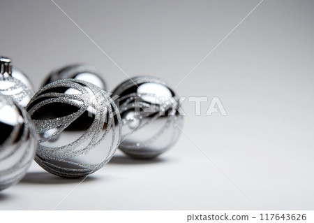 A row of shiny silver Christmas ornaments A row of shiny silver Christmas ornaments 117643626
