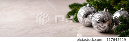A white background with four silver Christmas ornaments on it A white background with four silver Christmas ornaments on it 117643629