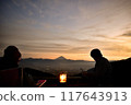 Person watching the sunset 117643913