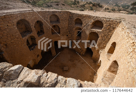 Preserved cave dwellings into walls of earthen pit in Matmata 117644642