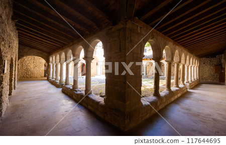 Ancient columned passageways surrounding cloister of Sant Llorenc de Morunys 117644695