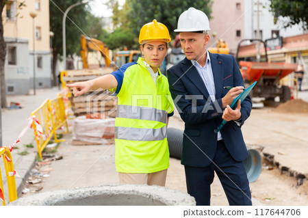 Male and female engineers in construction area Male and female engineers in construction area 117644706