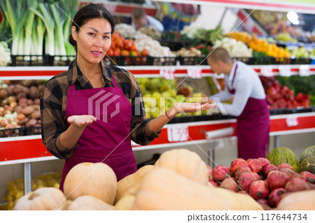 Woman presenting assortment in greengrocer 117644734