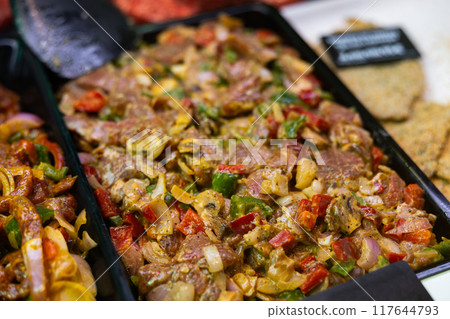 Marinated lamb with vegetables ready for stir-fry on store display Marinated lamb with vegetables ready for stir-fry on store display 117644793