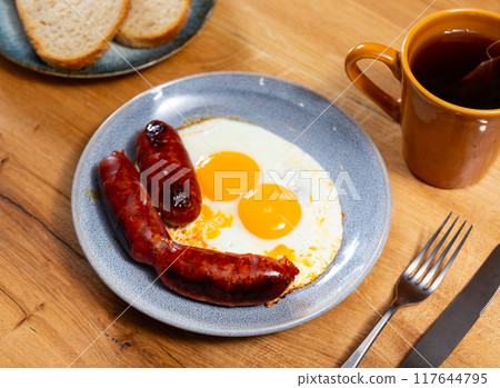 Homemade hearty breakfast - fried eggs with chorizo sausage. 117644795