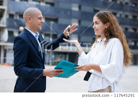 Real estate manager giving keys to woman Real estate manager giving keys to woman 117645291