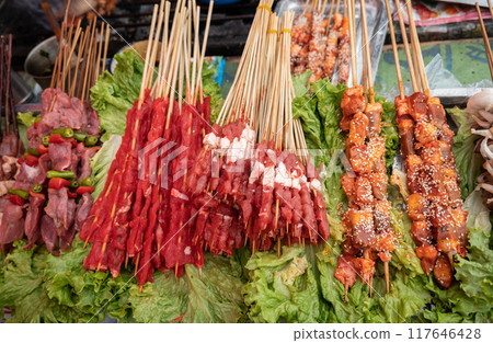 Yak skewer selling in local market in Shangri-la town of China. Yak meat is a high-protein and low-fat-containing food. Yak skewer selling in local market in Shangri-la town of China. Yak meat is a high-protein and low-fat-containing food. 117646428