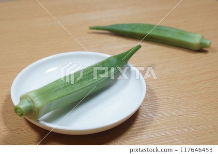 Okra plants passing by each other 117646453