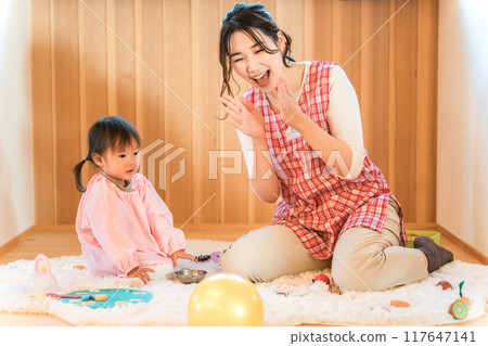 Children playing at a nursery school, kindergarten, daycare center, or daycare center and childcare workers and babysitters 117647141