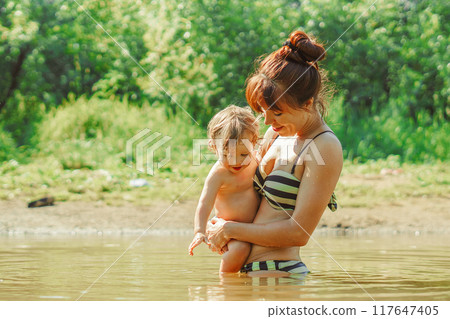 mom and child swim in the river 117647405
