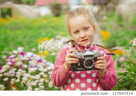 A little girl with a camera A little girl with a camera 117647414