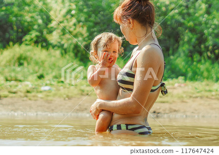 mom and child swim in the river 117647424